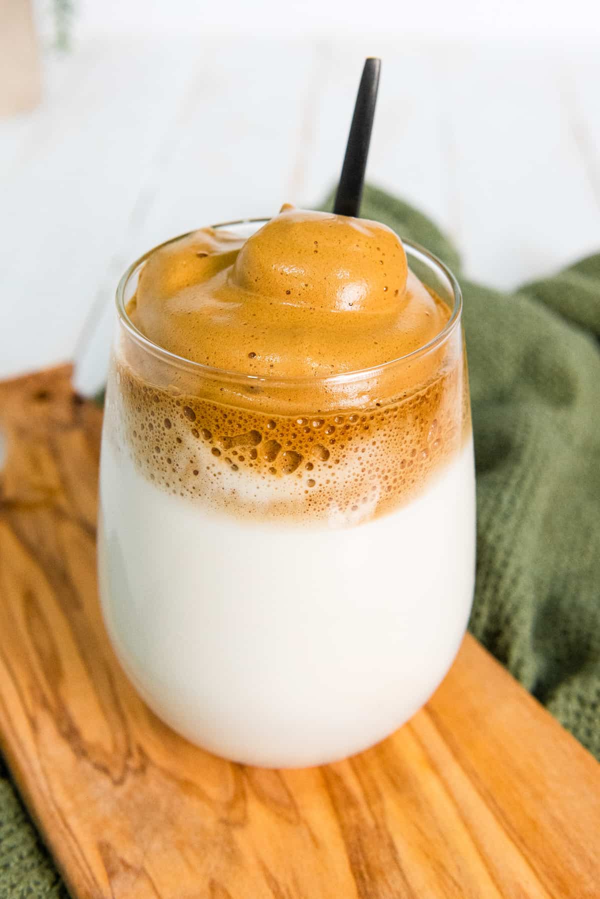 a glass of milk topped with whipped coffee