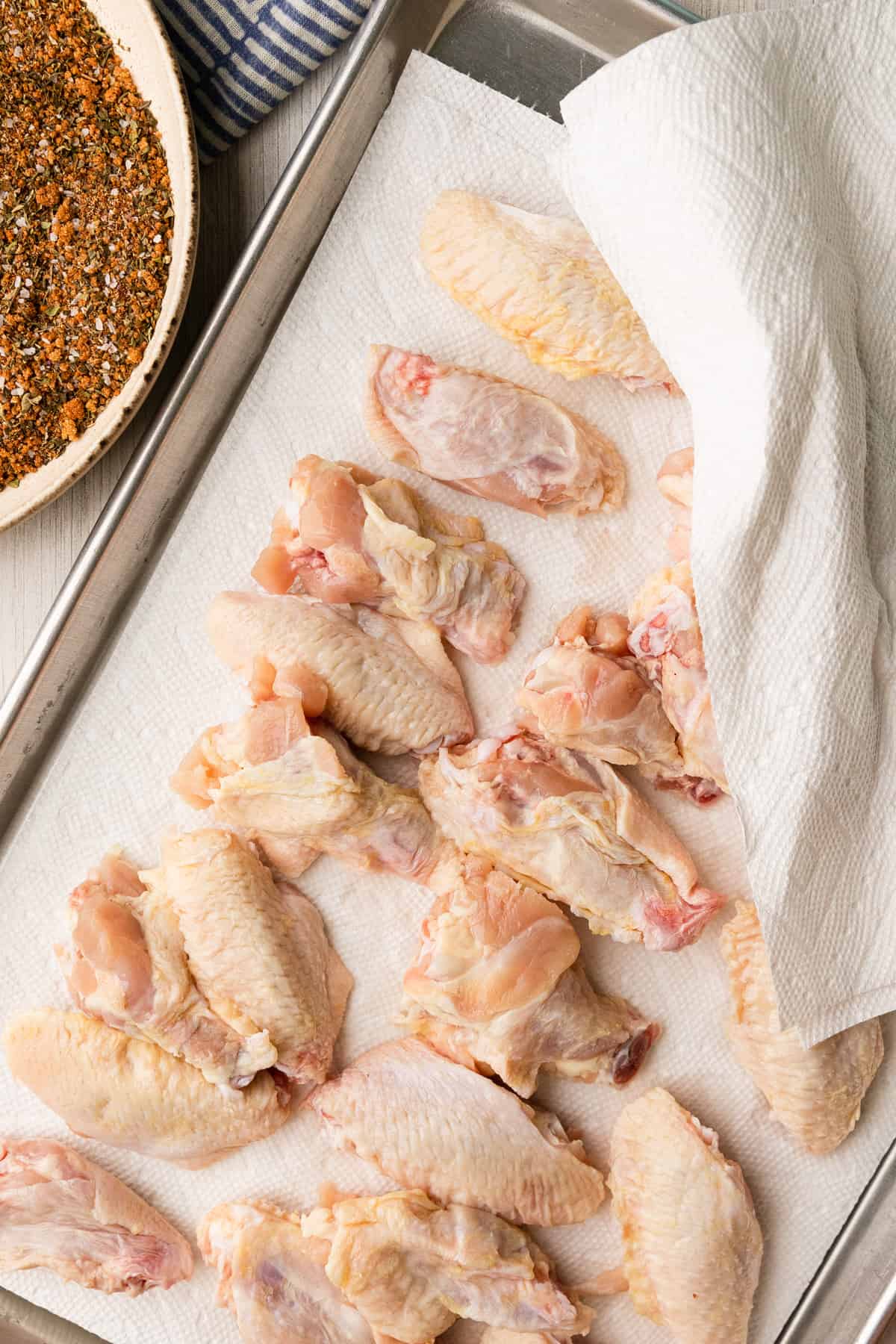 raw chicken wings with paper towels