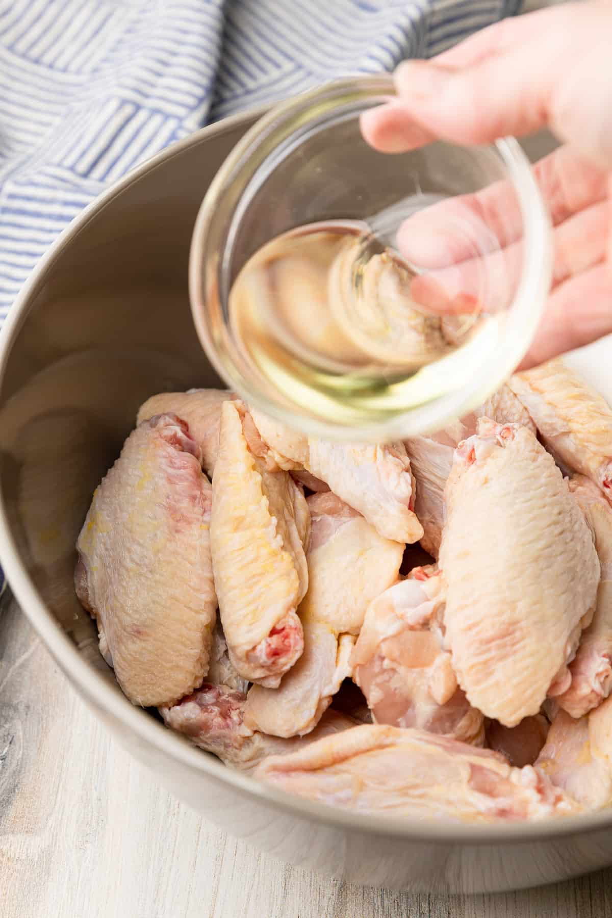 add oil to a bowl of raw chicken wings