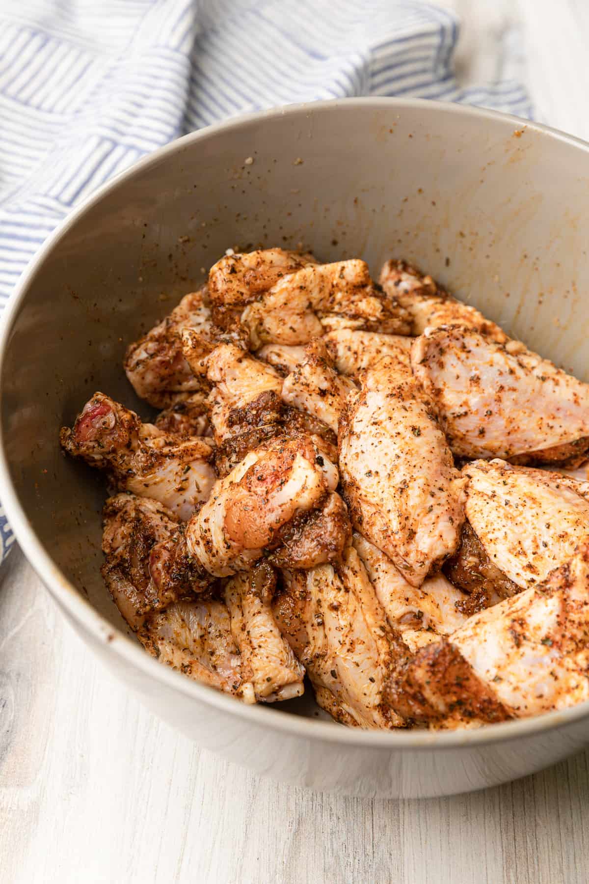 spices covering raw wings.