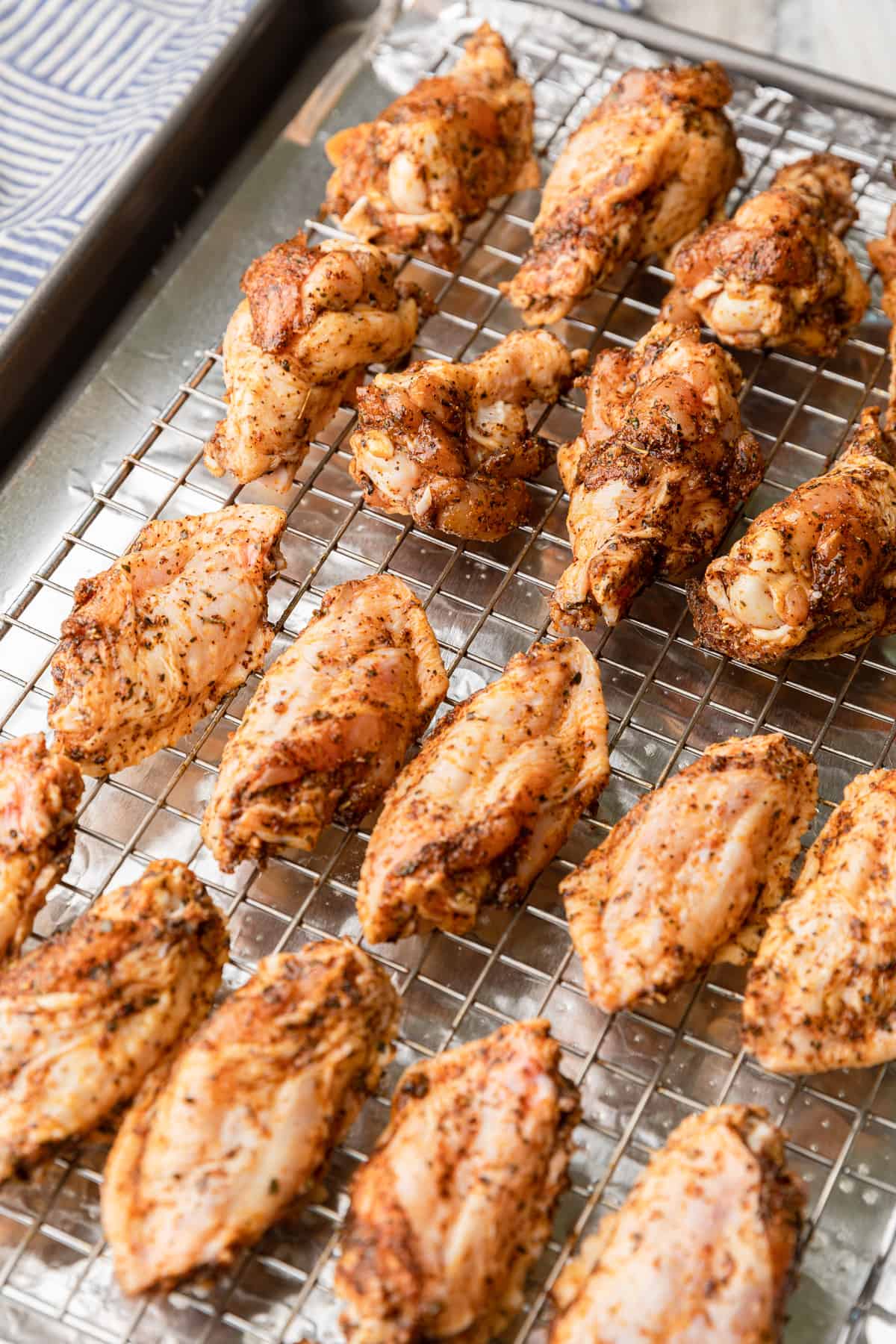 raw wings placed on a cooking rack.