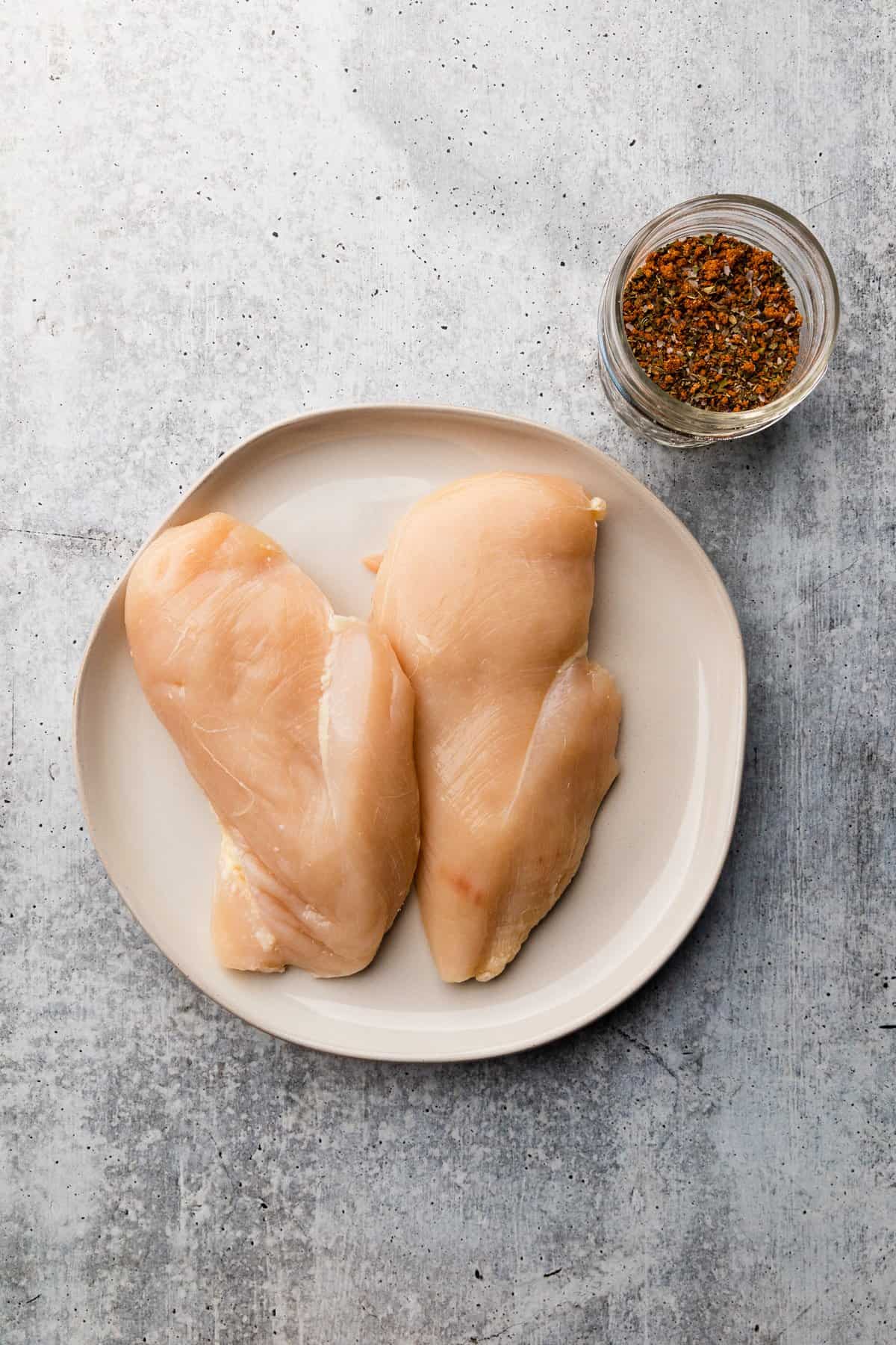 plain raw chicken breasts on a plate