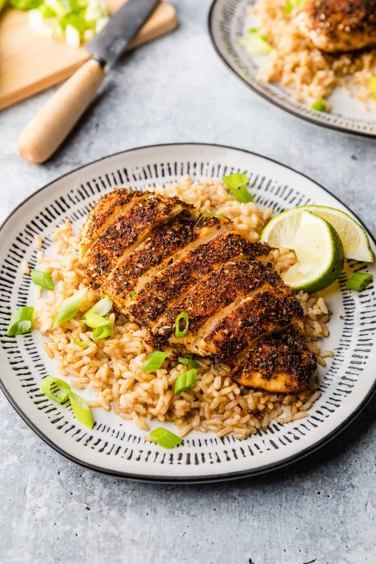 a piece of blackened chicken with rice