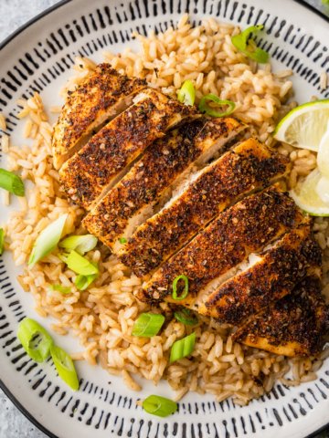 air fryer blackened chicken on a plate with rice