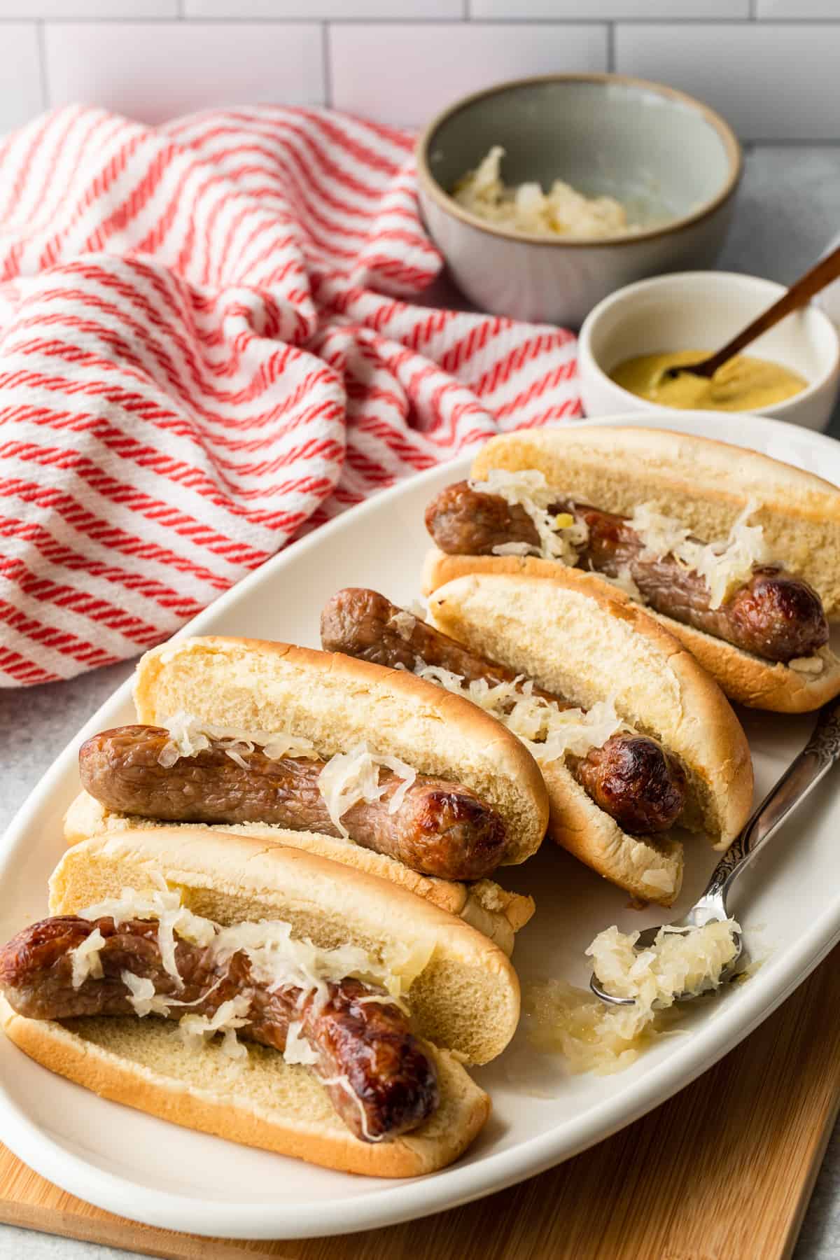 a platter of air fried bratwurst in buns