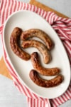 a platter of cooked brats
