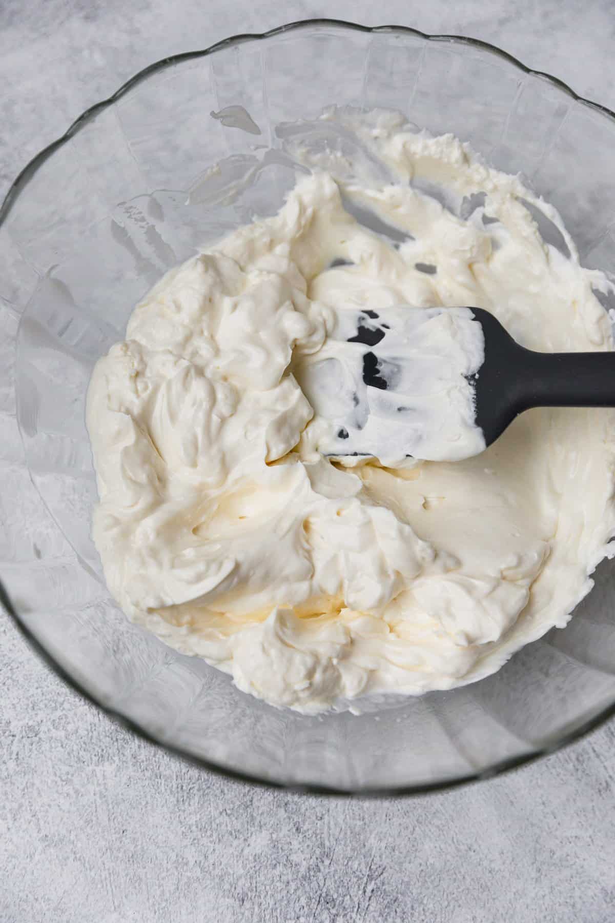 mixing cream cheese for the recipe