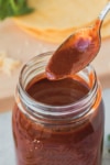 thickened sauce being stored in a glass jar