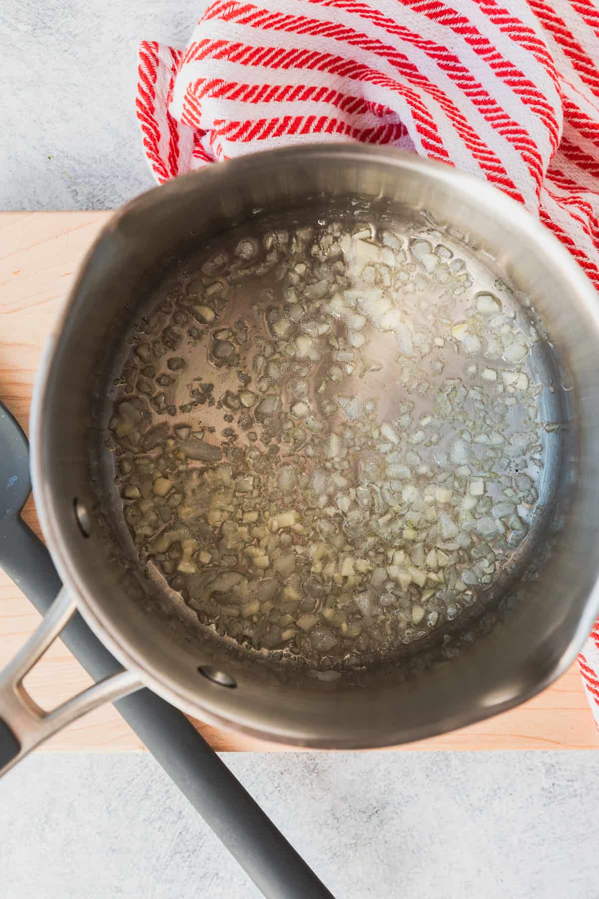 cooking onions and garlic in a saucepan