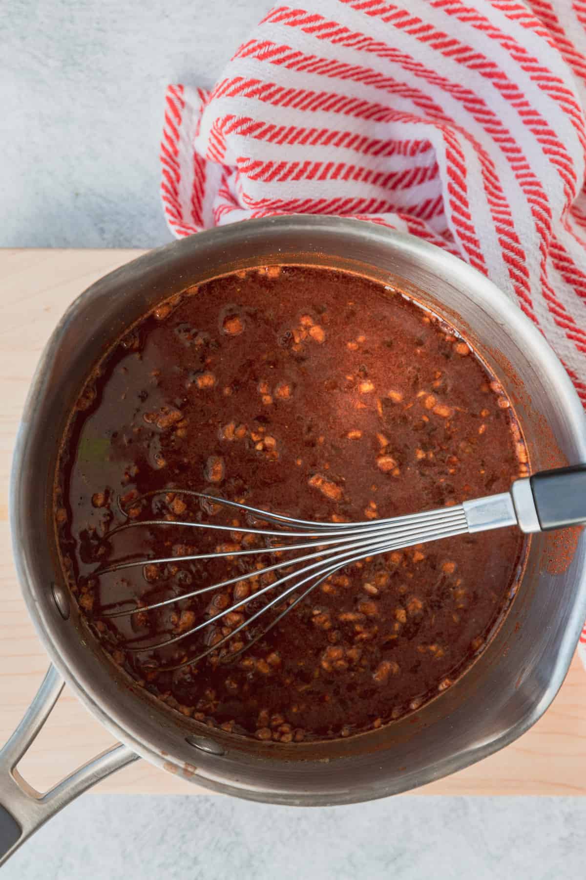 adding chile mixture to saucepan to thicken