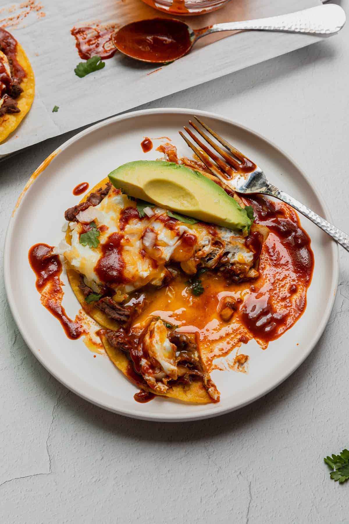 a plate of huevos rancheros being eaten