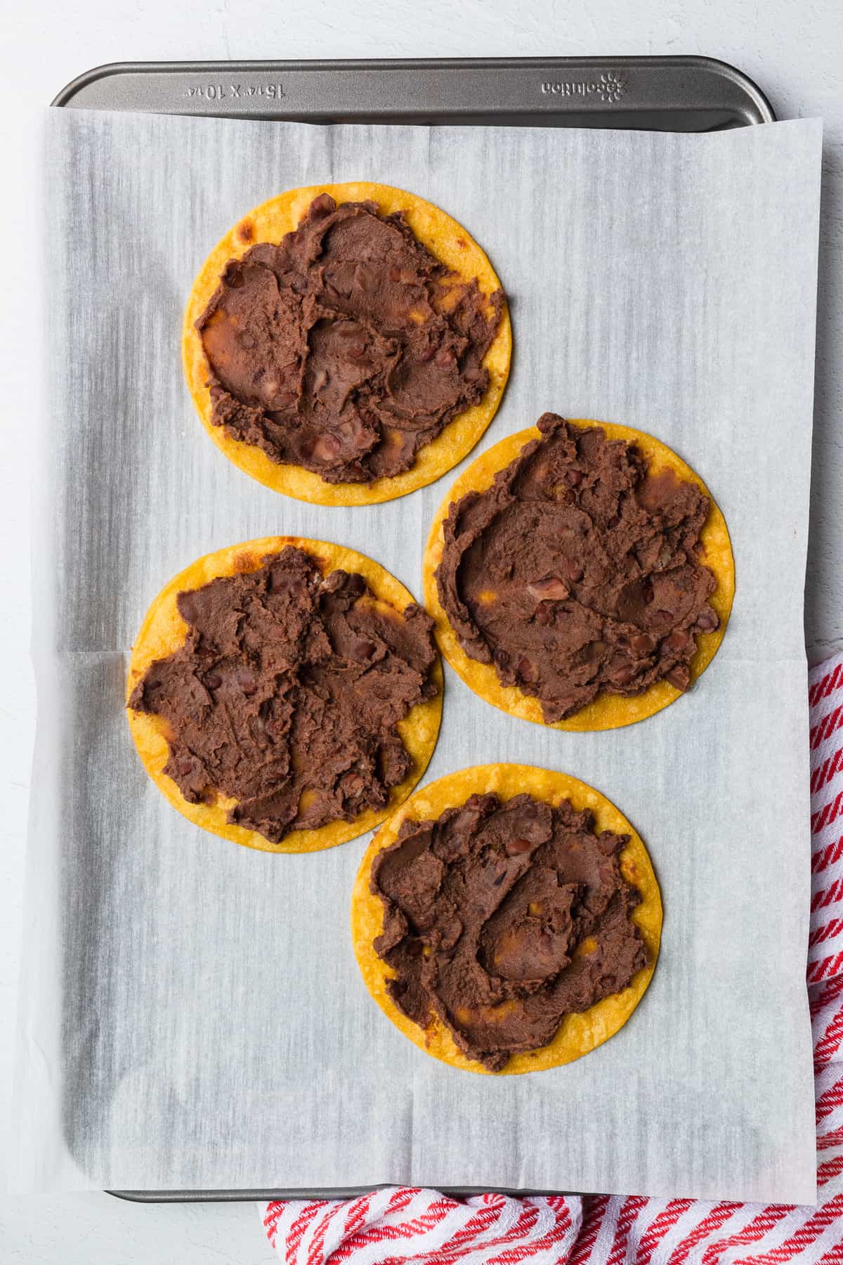 refried beans spread on corn tortillas