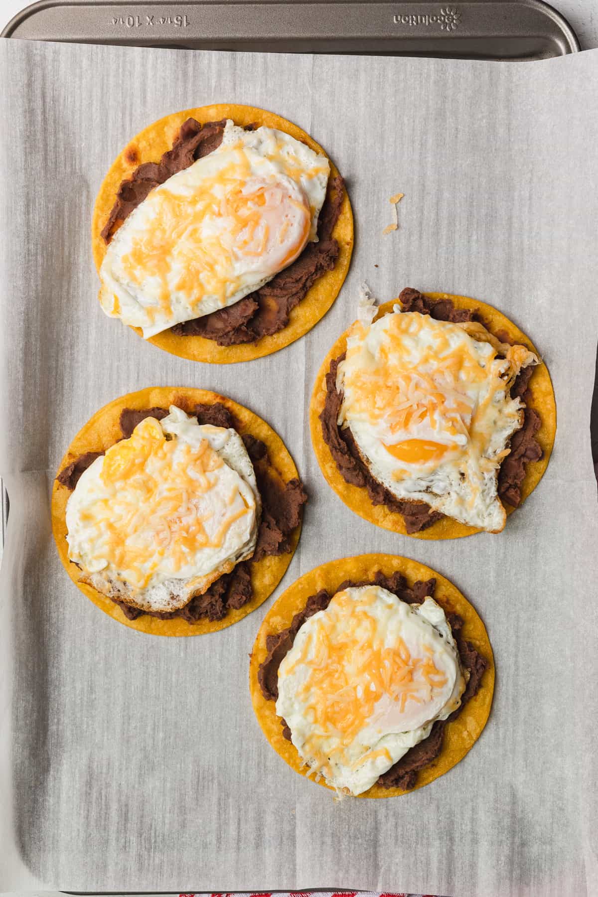 Eggs placed on refried beans and tortillas