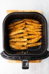cooked steak fries in an air fryer basket