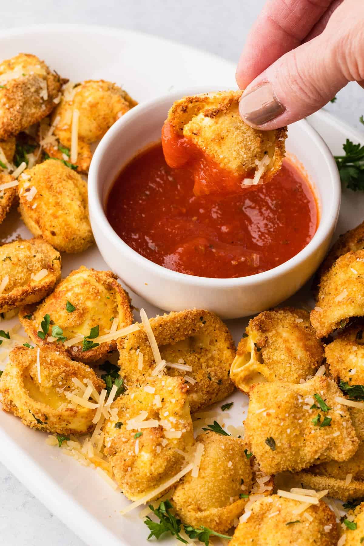 a crispy air fryer tortellini with pizza sauce dip