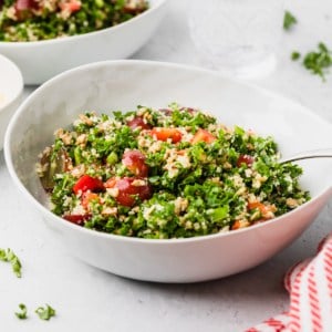 kale salad copycat recipe in a white salad bowl