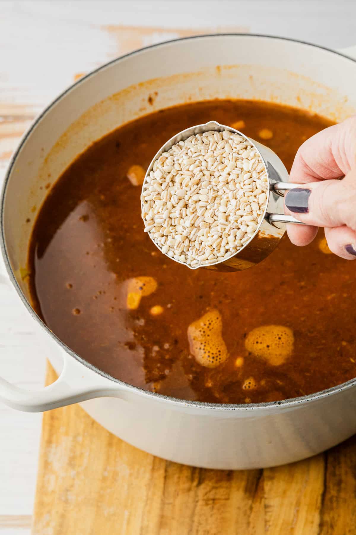 adding barley to make soup