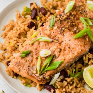 cajun baked salmon on a plate with dirty rice