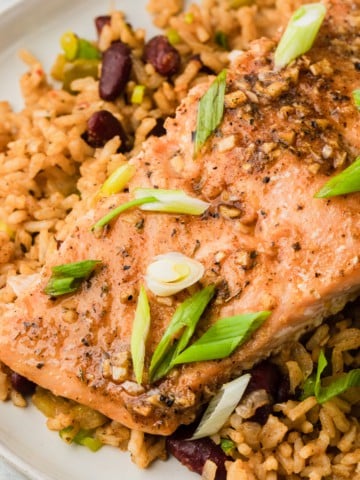 cajun baked salmon on a plate with dirty rice