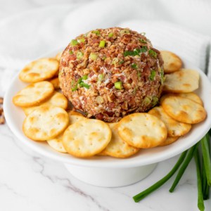 holiday cheese ball with crackers on a platter