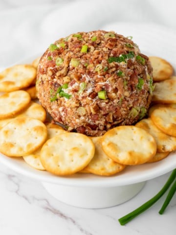 holiday cheese ball with crackers on a platter