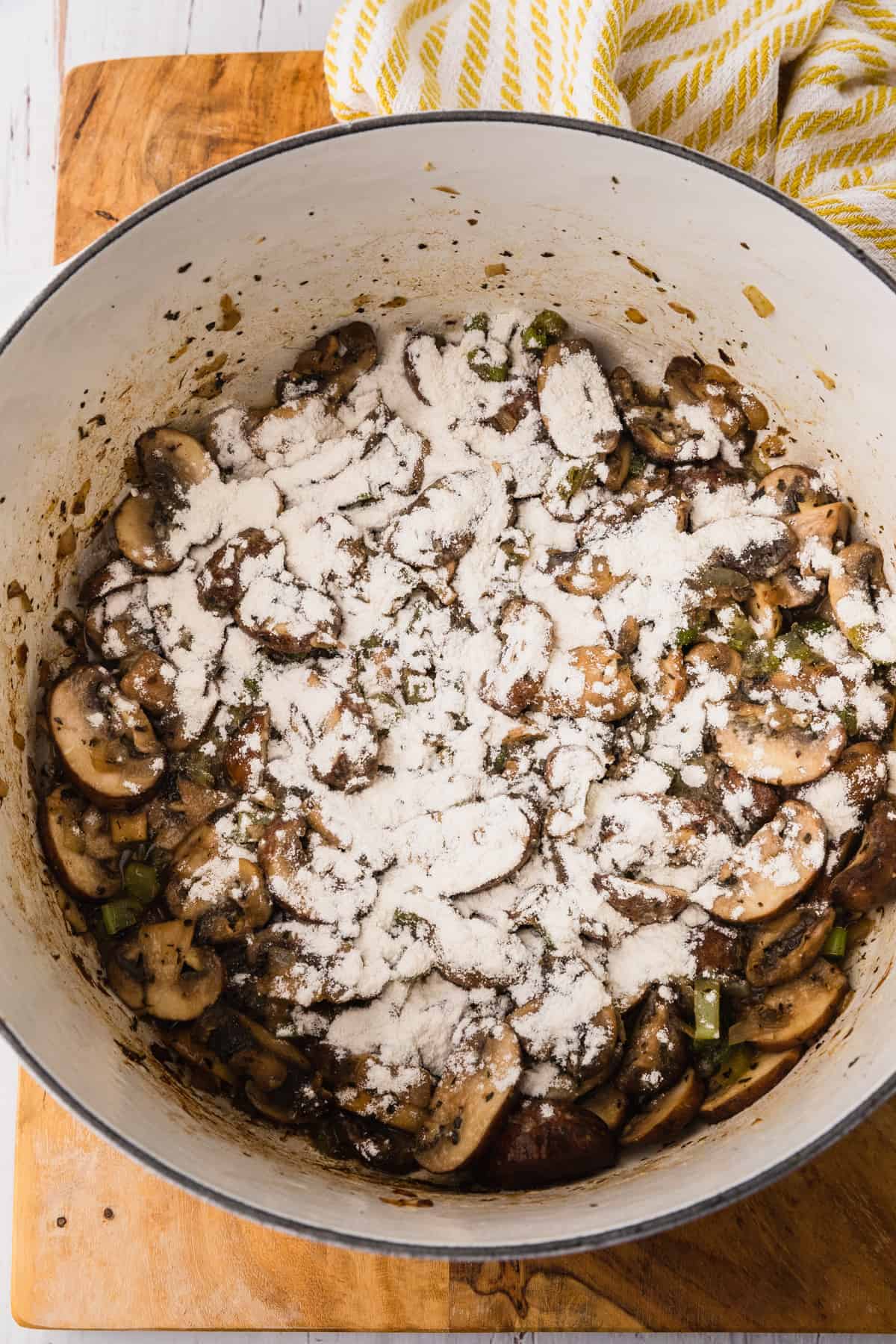 flour sprinkled over cooked mushrooms