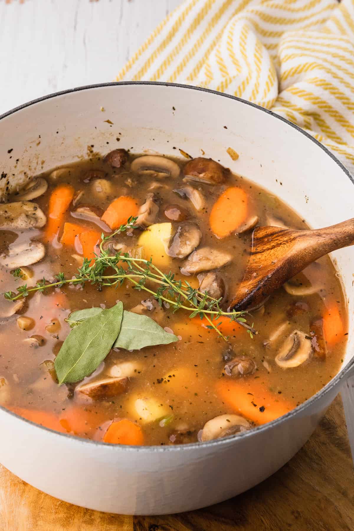 adding fresh herbs to soup pot