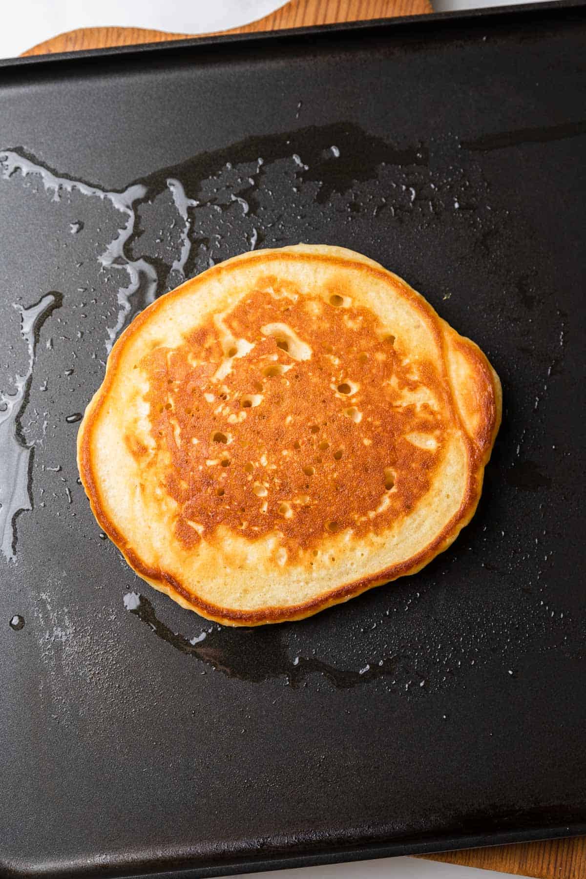 cooking a pancake on a griddle