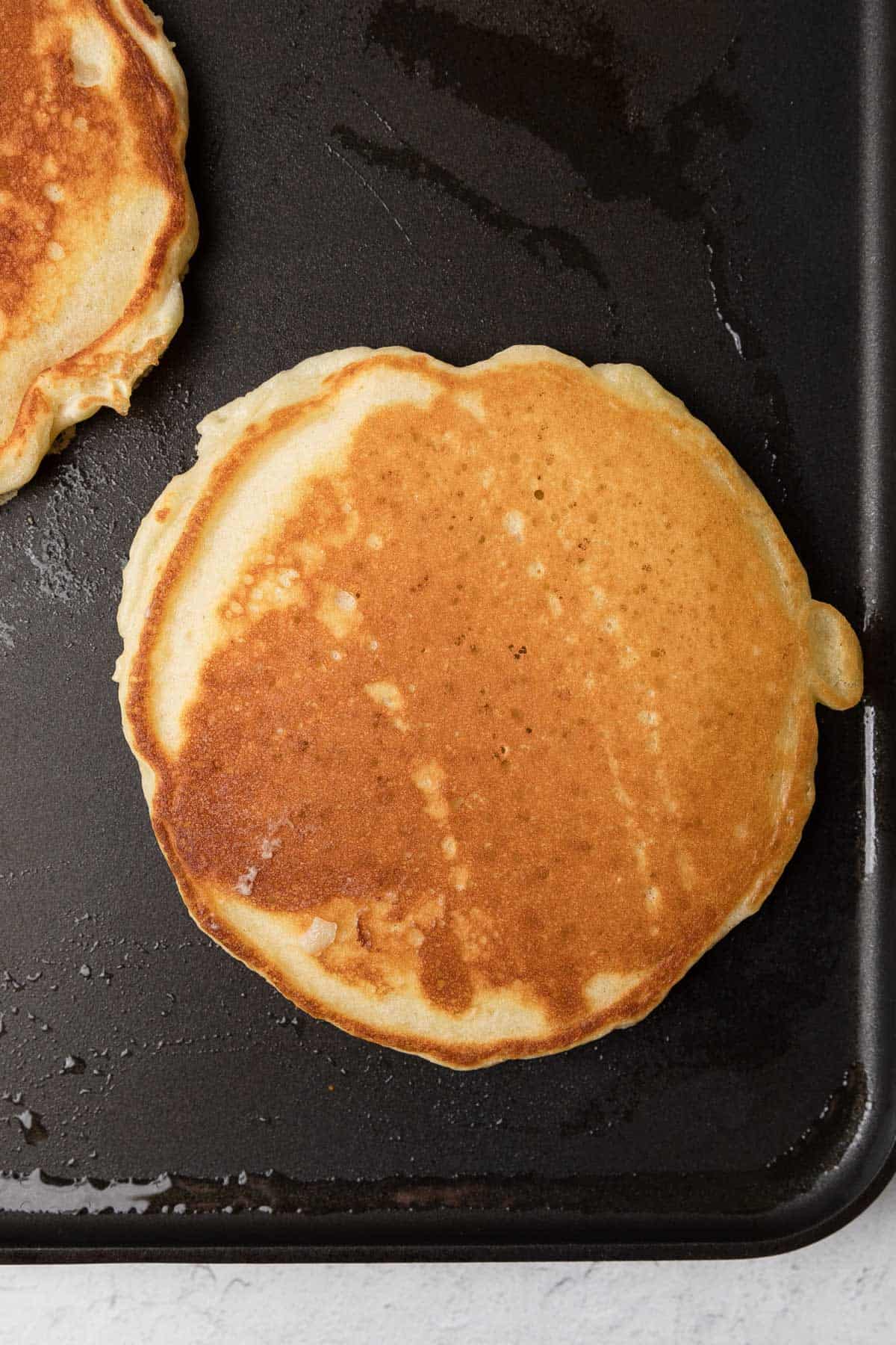 cooking a pancake on a griddle