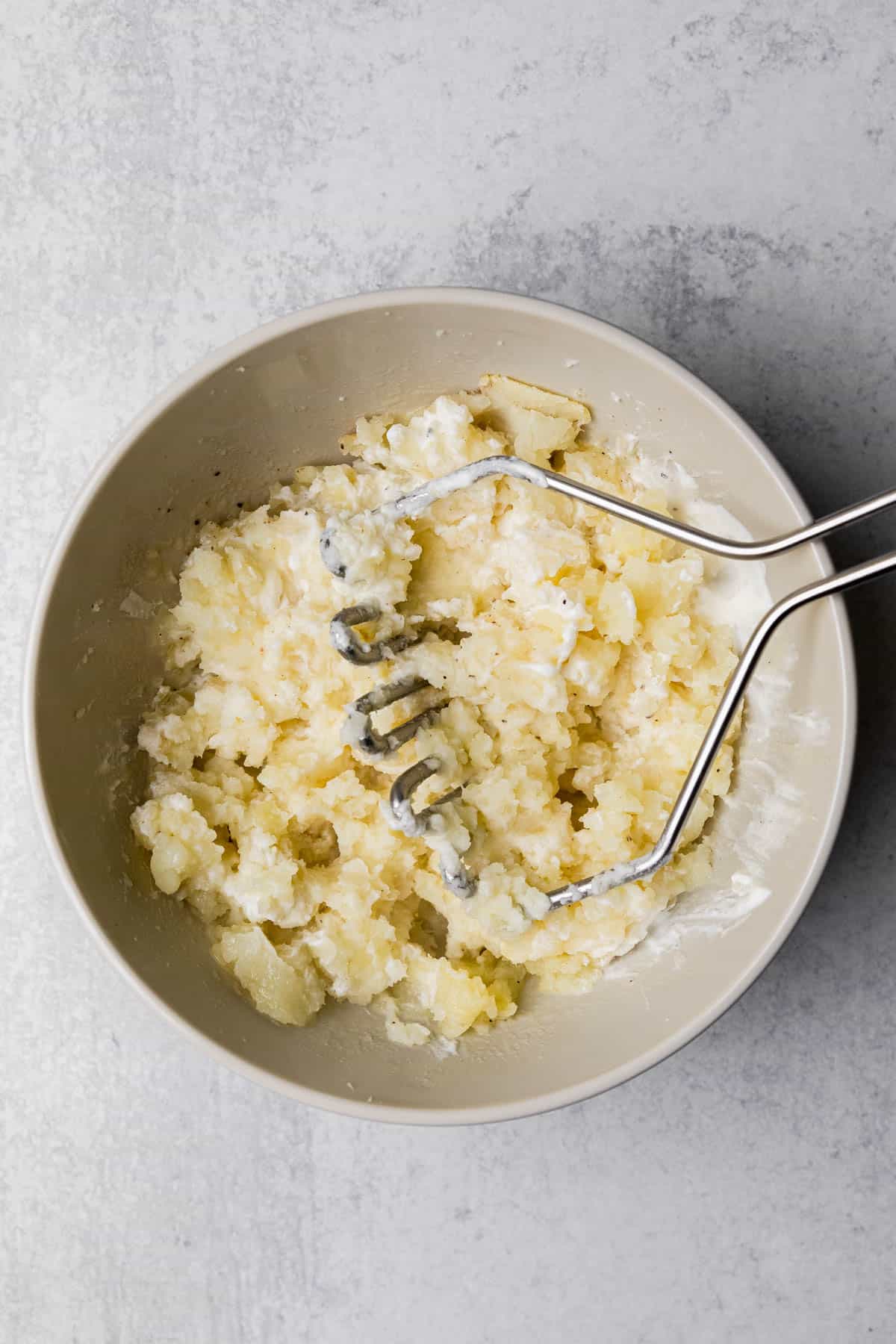 mashing the potatoes