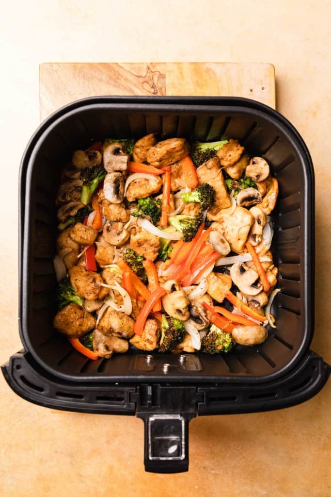 air fryer basket filled with the recipe ingredients after cooking