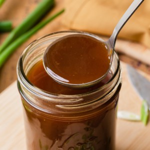 a glass jar with brown gravy
