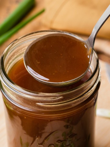 a glass jar with brown gravy