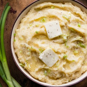 a bowl of mashed potatoes with melting butter on top