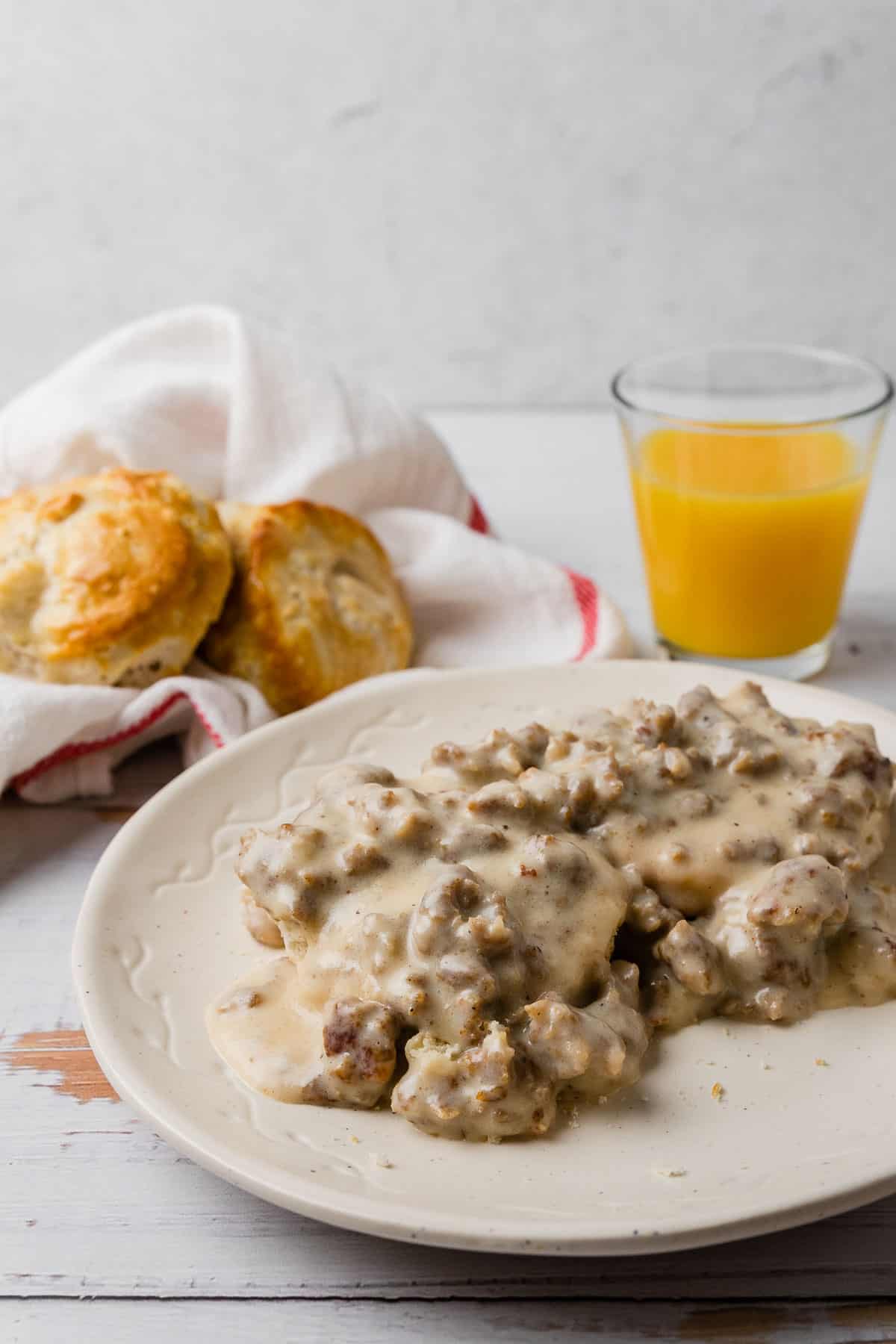 a breakfast scene with biscuits and sausage gravy