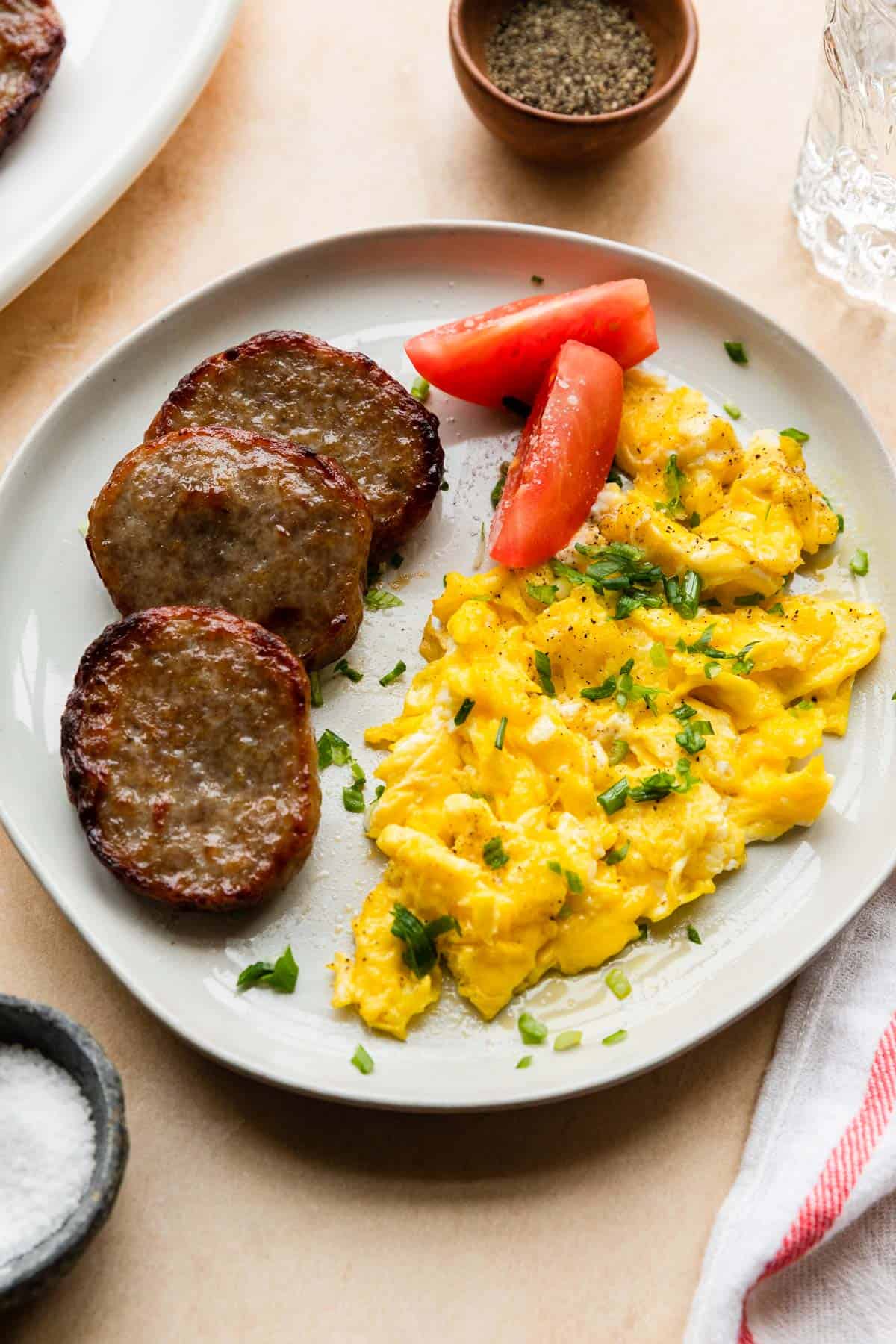 a plate of eggs and air fryer breakfast sausage patties