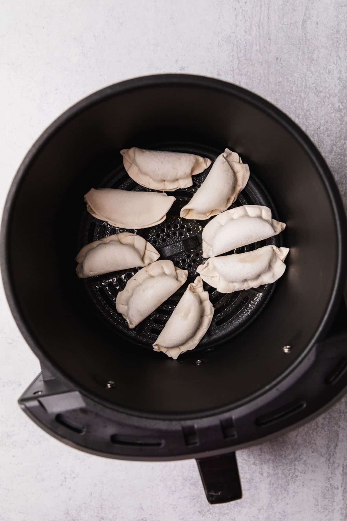 uncooked potstickers in the air fryer basket