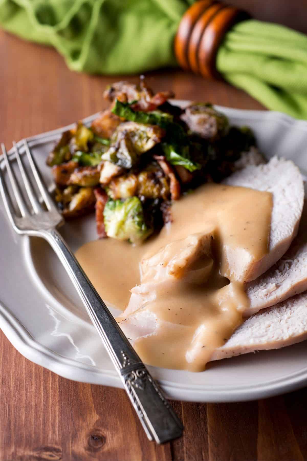 a plate of turkey smothered in gravy