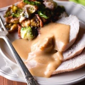 a plate of gravy and turkey