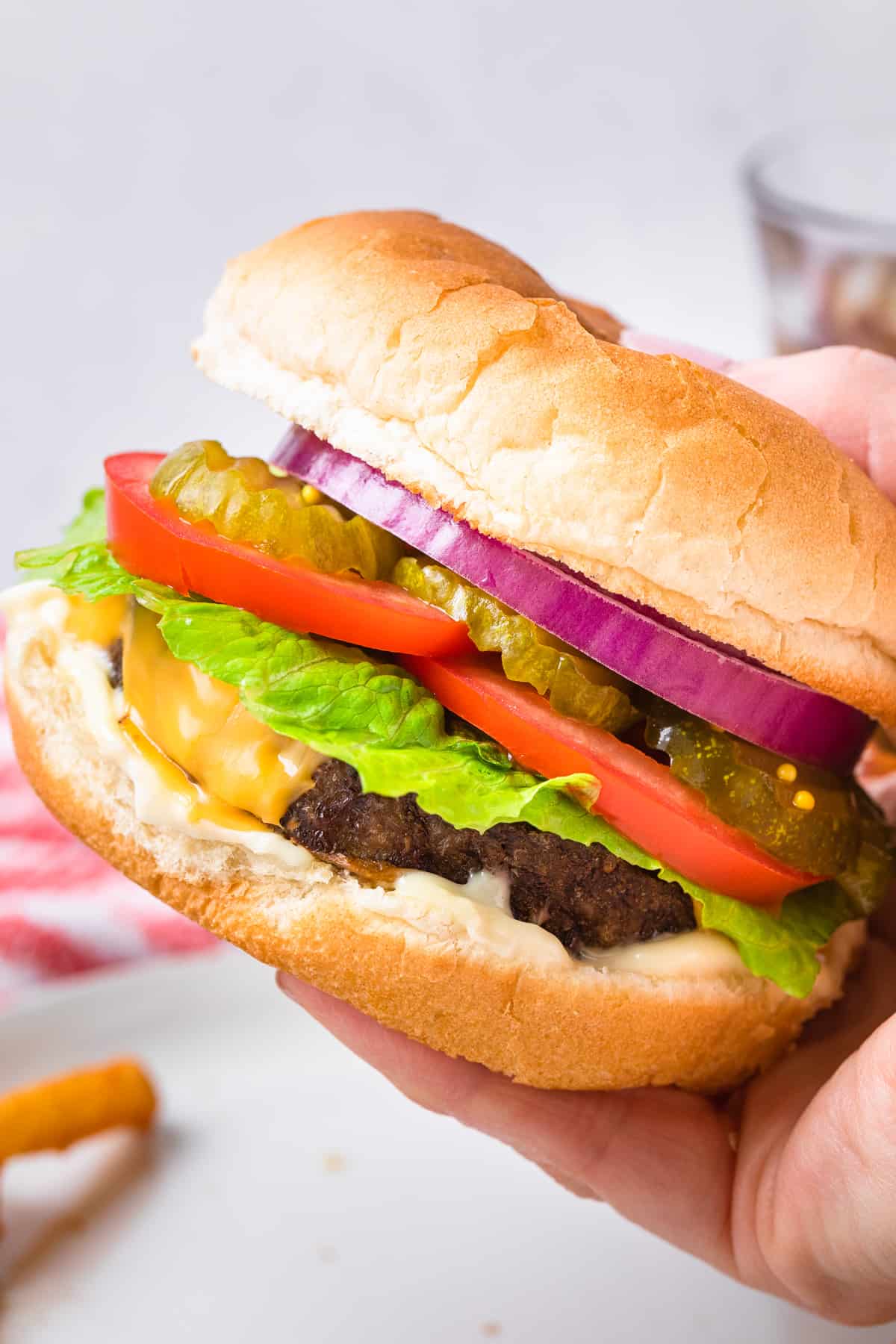 the completed cheeseburger recipe in someone's hand