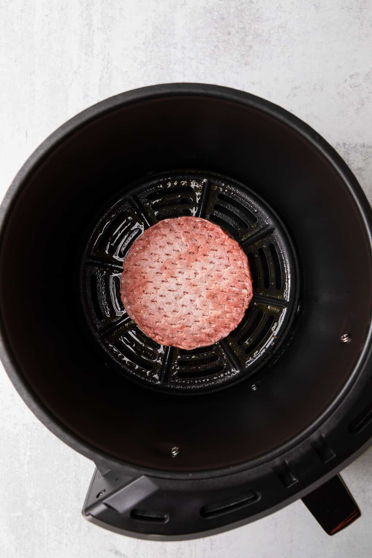 the frozen burger in the air fryer basket 