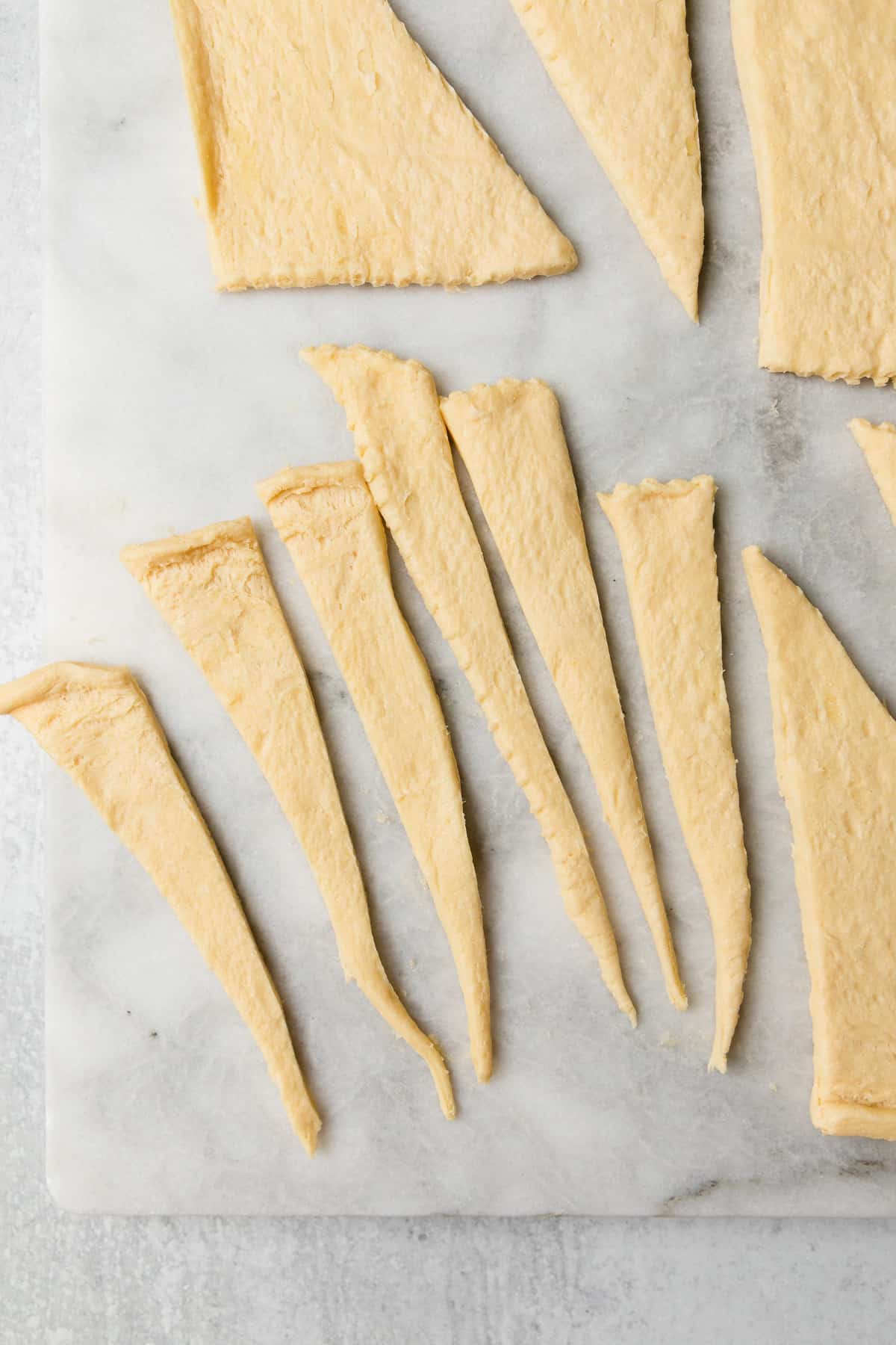 Cutting the dough into equal strips.