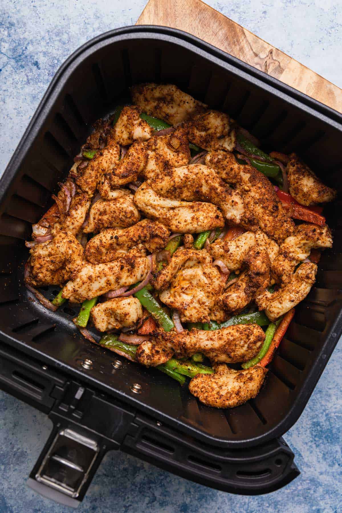 chicken in air fryer basket cooked halfway