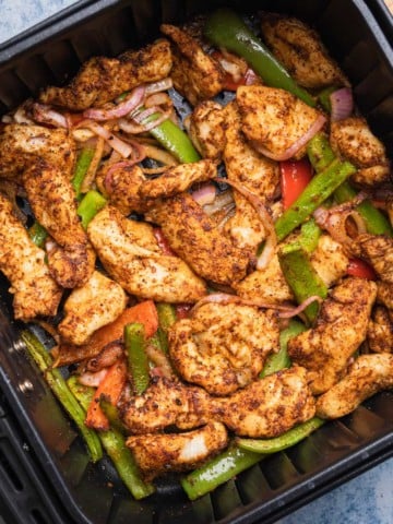 the completed air fryer fajitas in the basket.