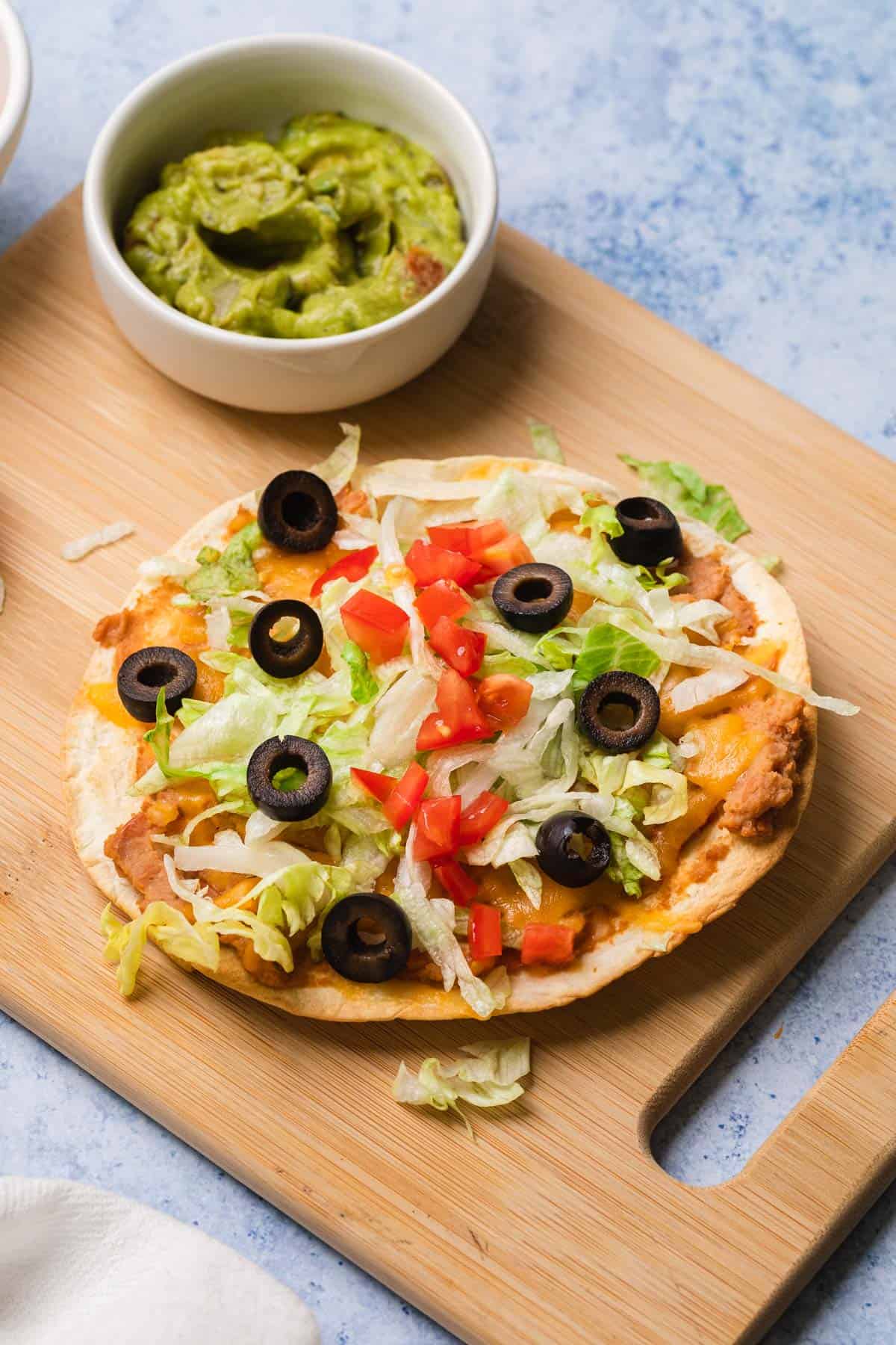 a completed bean and cheese tostada that was made in an air fryer