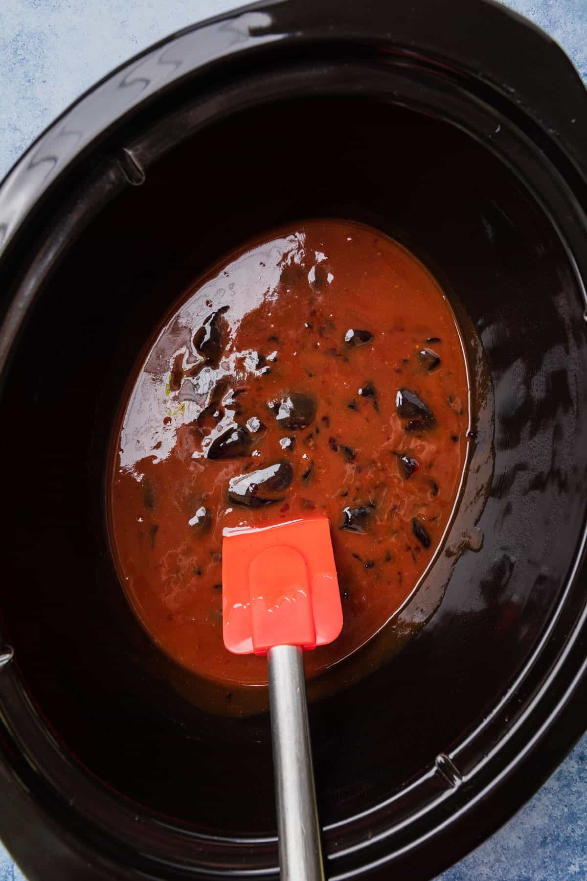 making lil smokies with grape jelly and bbq sauce in the crockpot