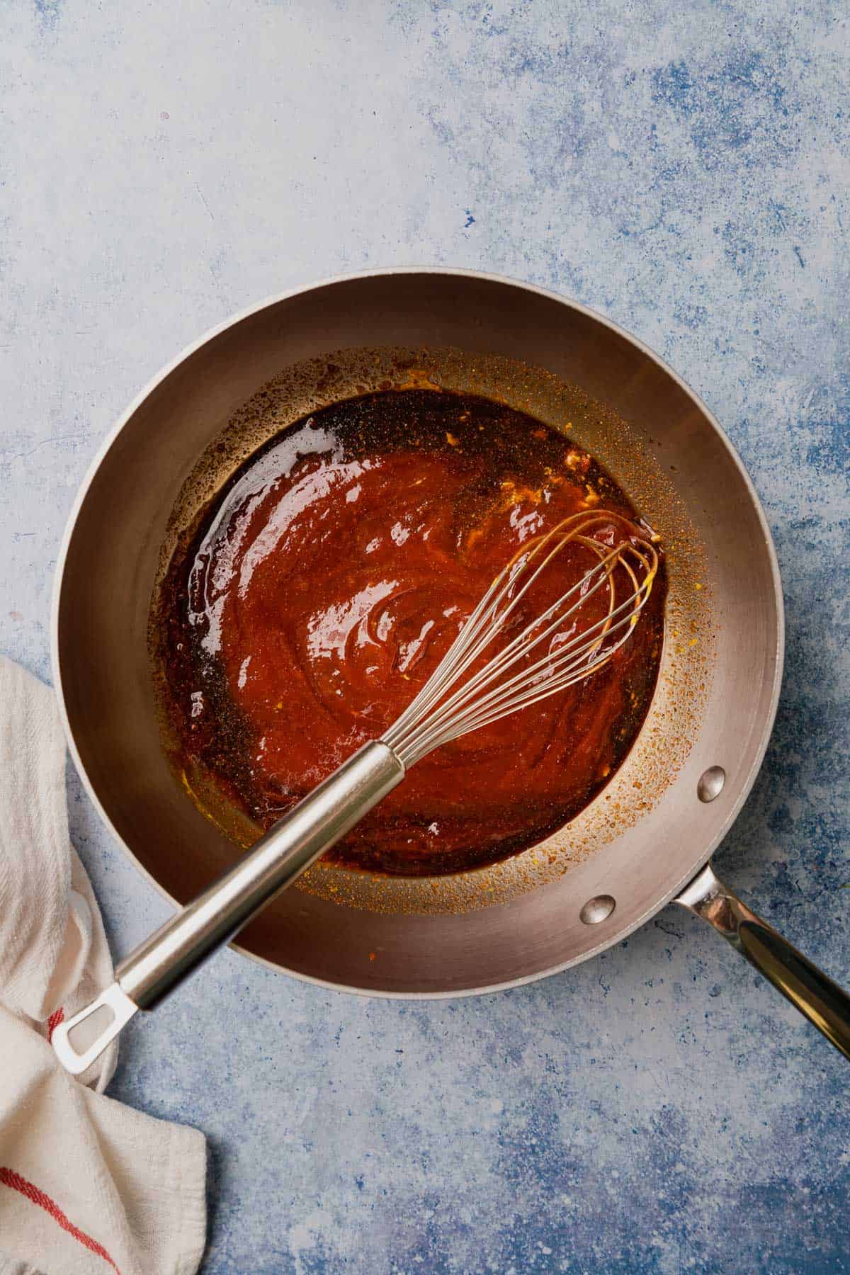 making the bbq sauce with ketchup in a sauce pan