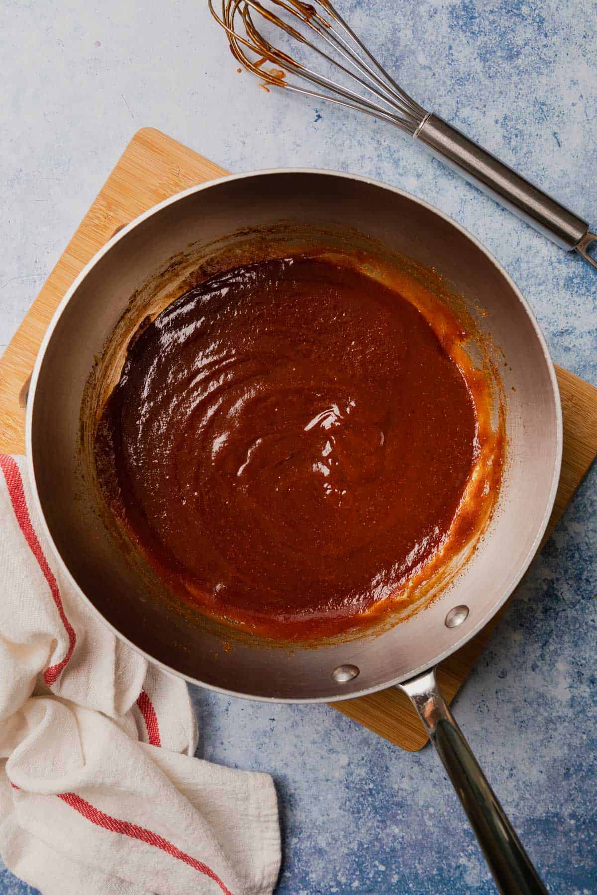 making the bbq sauce with ketchup in a sauce pan