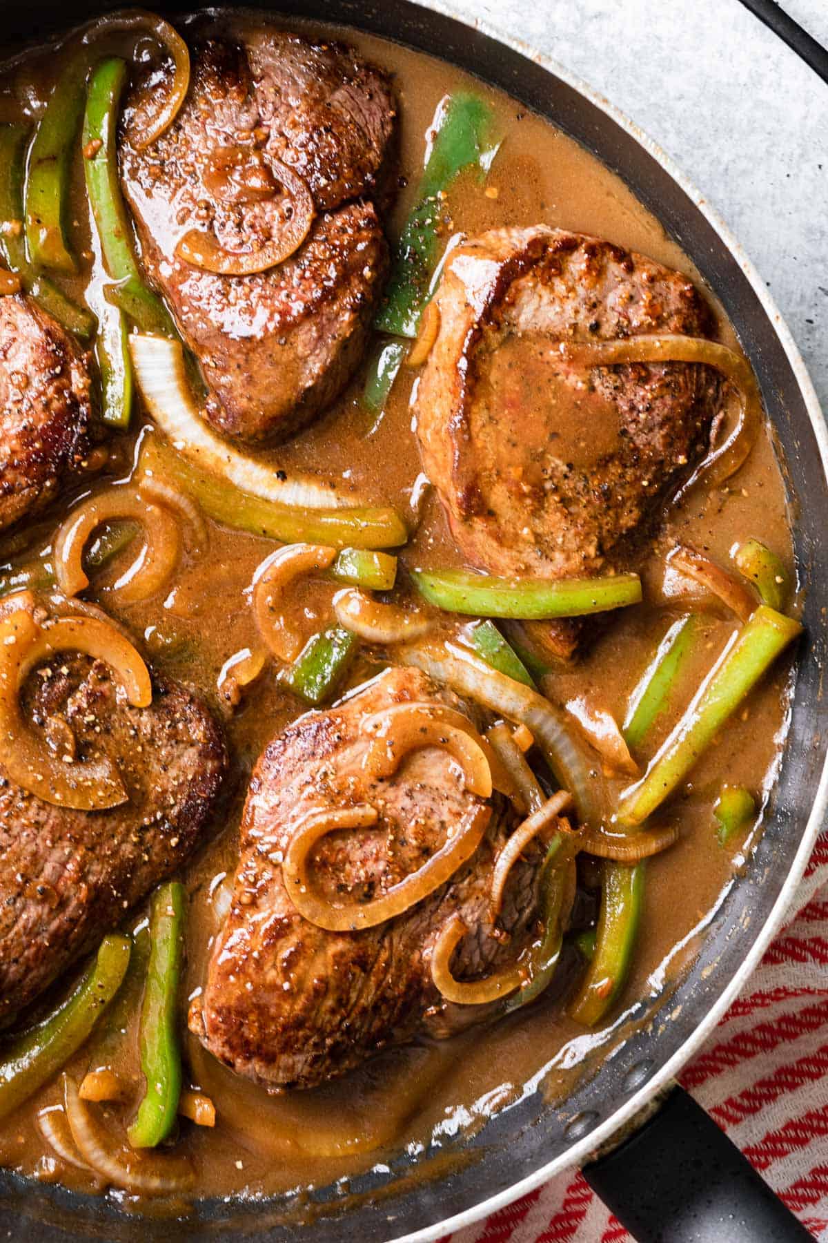 a complete recipe of pepper steak and gravy in a skillet
