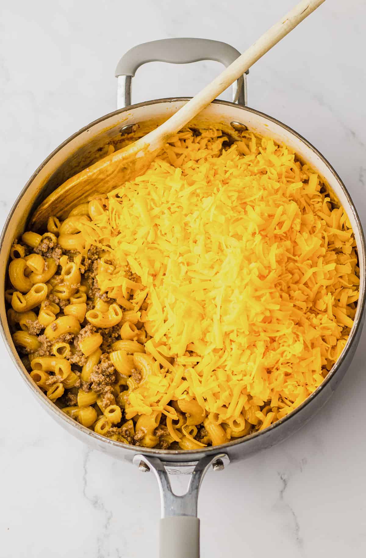 Stir in cheddar cheese when pasta is al dente.